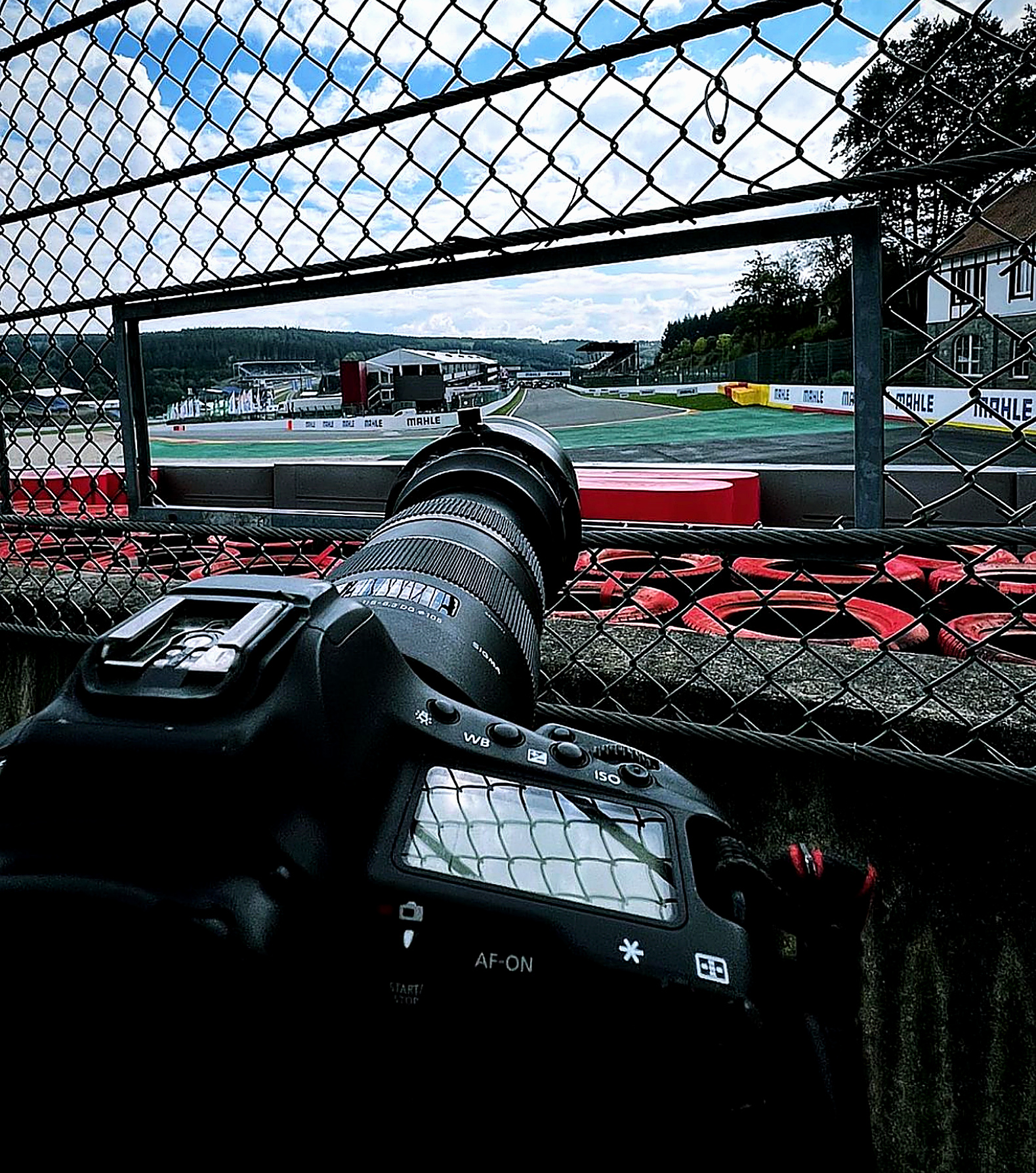 Camera pointed through the fence onto the race track